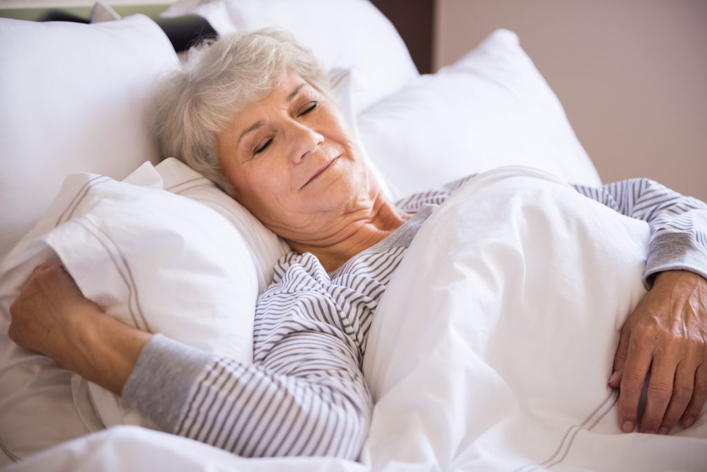 resized senior woman sleeping big bed
